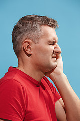 Image showing Young man is having toothache.