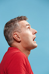 Image showing Portrait of the scared man on blue