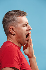 Image showing Beautiful bored man bored isolated on blue background