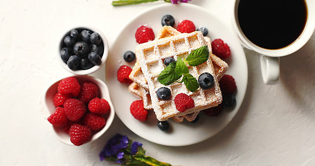 Image showing Coffee and berries near waffles