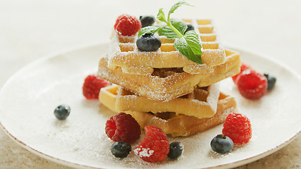Image showing Waffles served on plate with berries