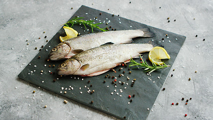 Image showing Spices and lemon lying near uncooked fish