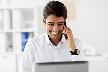 Image showing businessman calling on smartphone at office