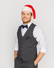 Image showing happy man in santa hat and suit at christmas