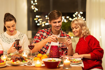 Image showing happy friends having christmas dinner at home