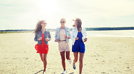 Image showing group of smiling women in sunglasses on beach