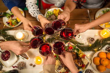 Image showing close up of friends with wine celebrate christmas