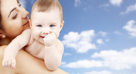 Image showing mother with baby over sky background