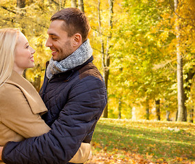 Image showing smiling couple hugging in autumn park