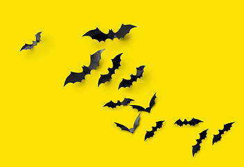 Image showing black halloween bats on yellow background