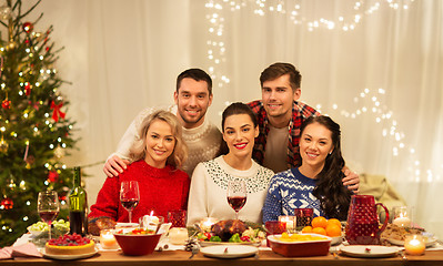 Image showing happy friends celebrating christmas at home