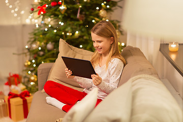 Image showing smiling girl with tablet pc at christmas home