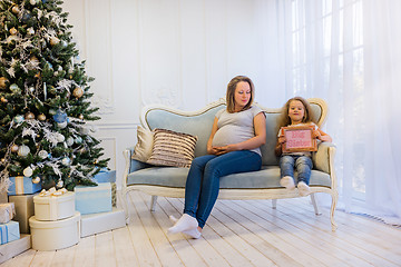 Image showing Beautiful pregnant woman sitting with doughter