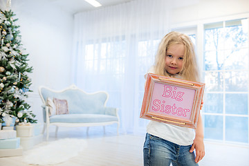 Image showing Cute girl standing near Christmas Tree