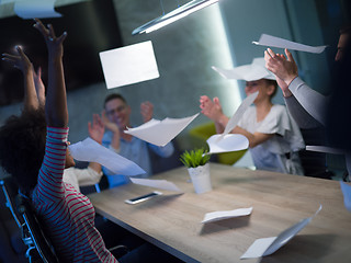 Image showing multiethnic Group of young business people throwing documents