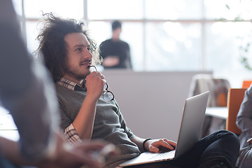 Image showing businessman working using a laptop in startup office