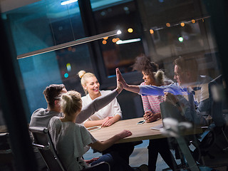 Image showing Multiethnic startup business team in night office