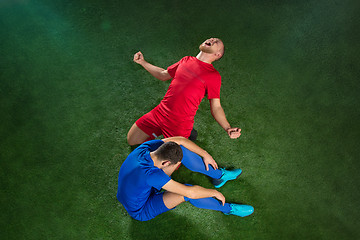 Image showing Happy and unhappy football players after goal