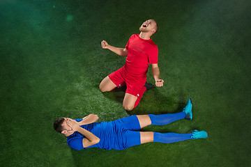 Image showing Happy and unhappy football players after goal
