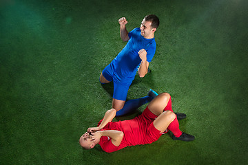 Image showing Happy and unhappy football players after goal