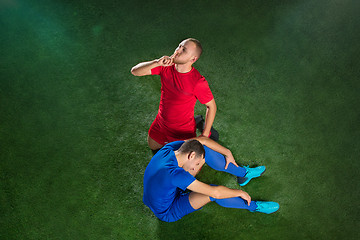 Image showing Happy and unhappy football players after goal