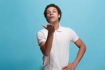 Image showing Portrait of attractive afro man with kiss isolated over blue background