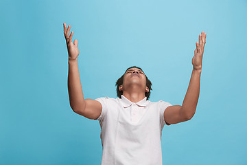 Image showing Beautiful man looking suprised and bewildered isolated on blue