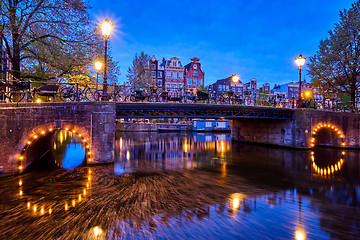 Image showing Amterdam canal, bridge and medieval houses in the evening