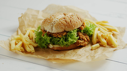 Image showing French fries and burger on parchment