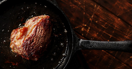 Image showing Skillet with roasted meat on table