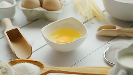 Image showing Utensils and ingredient around bowl with yolk