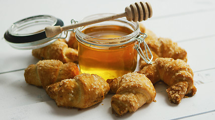 Image showing Jar with honey and croissants