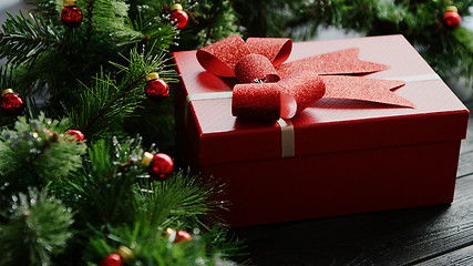 Image showing Christmas present near conifer branches with beads