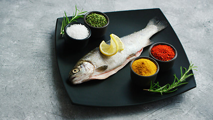 Image showing Spices lying on plate near fish