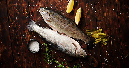 Image showing Fresh trout with lemon on board