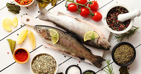 Image showing Aromatic spices and vegetables around fish