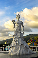 Image showing Sculpture of bride girl in dress with bouquet of bride flowers