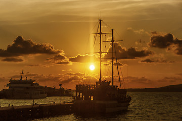 Image showing Sailing ship in seaport at sunset