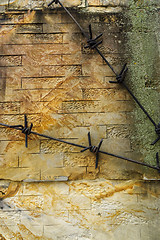 Image showing Conceptual gloomy wall background with texture and barbed wire