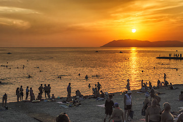 Image showing Tourists enjoy nature and sunset on beach of sea