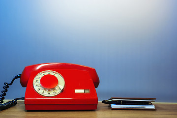 Image showing Outdated red rotary dial telephone