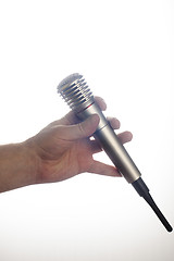 Image showing Male hand holds microphone on white background