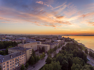 Image showing Aerial lakeside cityscape view at golden hour after sunset