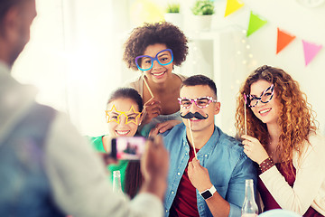 Image showing friends or team photographing at office party