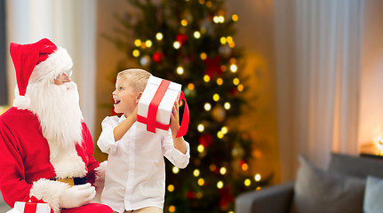 Image showing boy and santa with christmas gifts at home