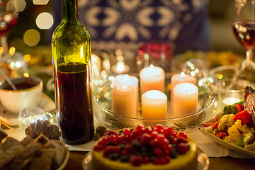 Image showing food, drinks and candles burning on table