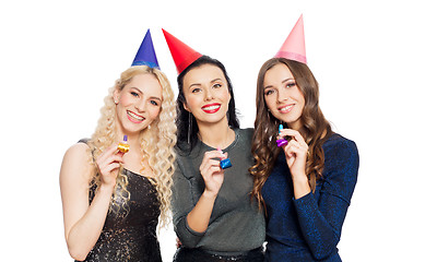 Image showing happy women with party caps hugging