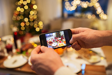 Image showing hands photographing food at christmas dinner