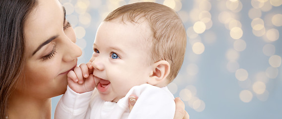 Image showing mother with baby over festive lights background