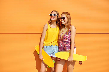 Image showing teenage girls with short skateboards outdoors